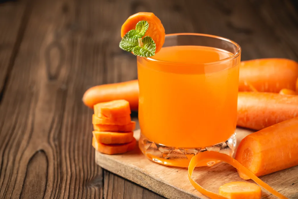 carrot juice glass on wooden table